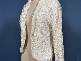 an image of a white jacket on a mannequin