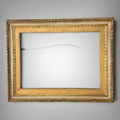 a picture of a gold framed mirror on the wall