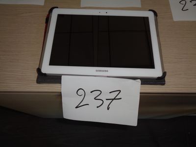 a tablet computer sitting on a table with a price tag on it