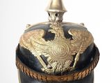 a black and gold hat with a bird on it