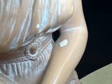 a statue of a woman that is sitting on a table