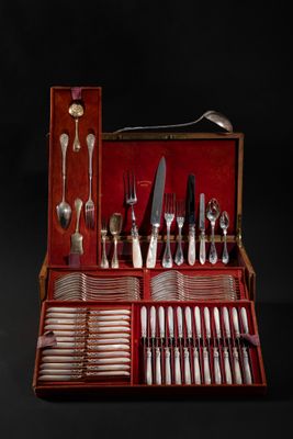 a red case with silverware in it on a black background