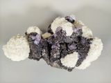 a piece of cauliflower with purple and white crystals on it