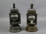 two small metal lanterns sitting on top of each other