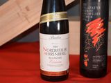 three bottles of wine sitting on a table next to each other