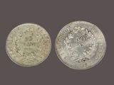 two silver coins, one of which has a crown and the other of which has a crown on it
