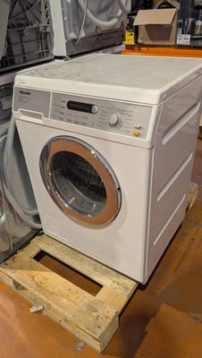 a washer and dryer sitting on a pallet in a store