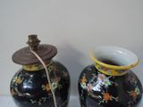 two vases that are sitting on a table