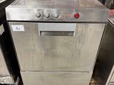 silver dishwasher sitting on pallets in a kitchen with other appliances