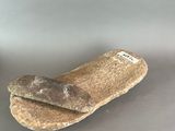 une miche de pain posée sur une table à côté d'une bouteille de bière