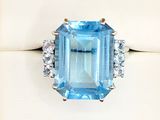 an image of a blue topaz ring with diamonds