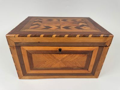 a wooden box with a star design on the lid