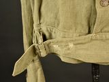 a close up of a shirt with a button on it