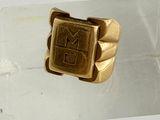 a gold ring with a number on it on a clear surface