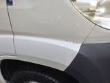 a white van with a black stripe on the side of it