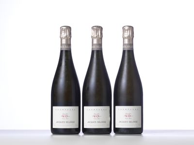 three bottles of wine are lined up on a table