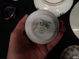 a person holding a white plate with a picture on it