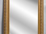 an ornate gold framed mirror with a white background