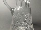 a glass pitcher that is sitting on a table