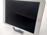 a tablet that is sitting on a stand on a table