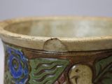 a close up of a vase with a flower design on it
