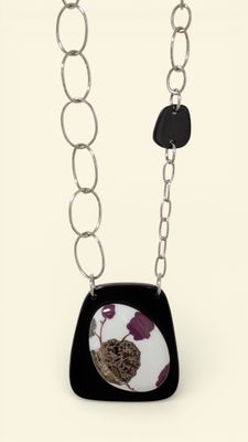 black and white necklace with a black and white picture of a bird