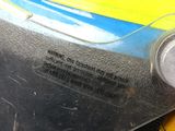 a close up of a yellow and blue car with a tag on it