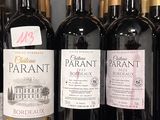 several bottles of wine are lined up on a shelf in a store