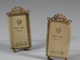 pair of antique brass bookends with a crown on each of them
