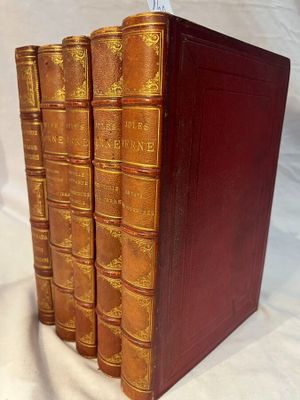 a set of five antique leather books on a white background