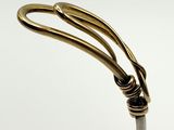 a close up of a metal object on a white surface