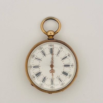 a gold pocket watch with roman numerals on the face