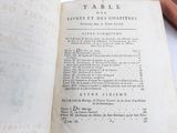 an old book open on a table with writing on it