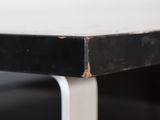 a close up of a black and white table with a white top