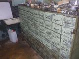 an old dresser with many drawers in a dirty room