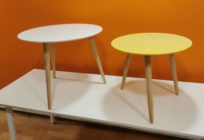 two tables that are sitting on a white table