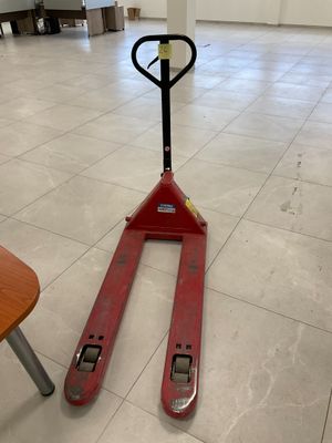 a fork lifter sitting in the middle of a room