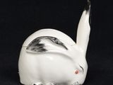 an image of a white rabbit figurine on a black background