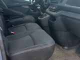 the interior of a car with the driver ' s seat folded down
