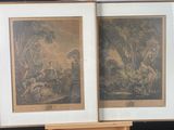 two framed pictures of a couple of animals on a table