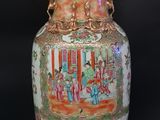 a large vase with a painting on it sitting on a table
