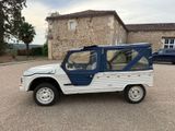 a white and blue jeep parked in front of a building