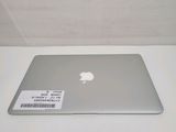 a silver apple laptop sitting on a white table