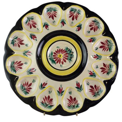 a close up of a plate with a flower design on it