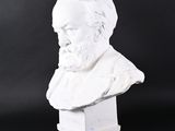 a white bust of a man with a beard on a black background