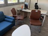a blue couch and a blue chair in a room