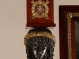 a clock that is on the wall next to a mirror
