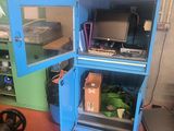 a blue cabinet with a computer inside of it