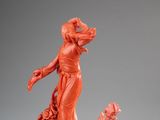 statue of a woman in a red dress with flowers on a pedestal