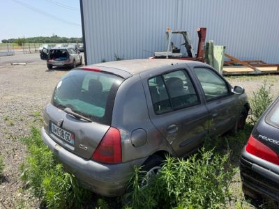 two cars that are parked next to each other in the grass